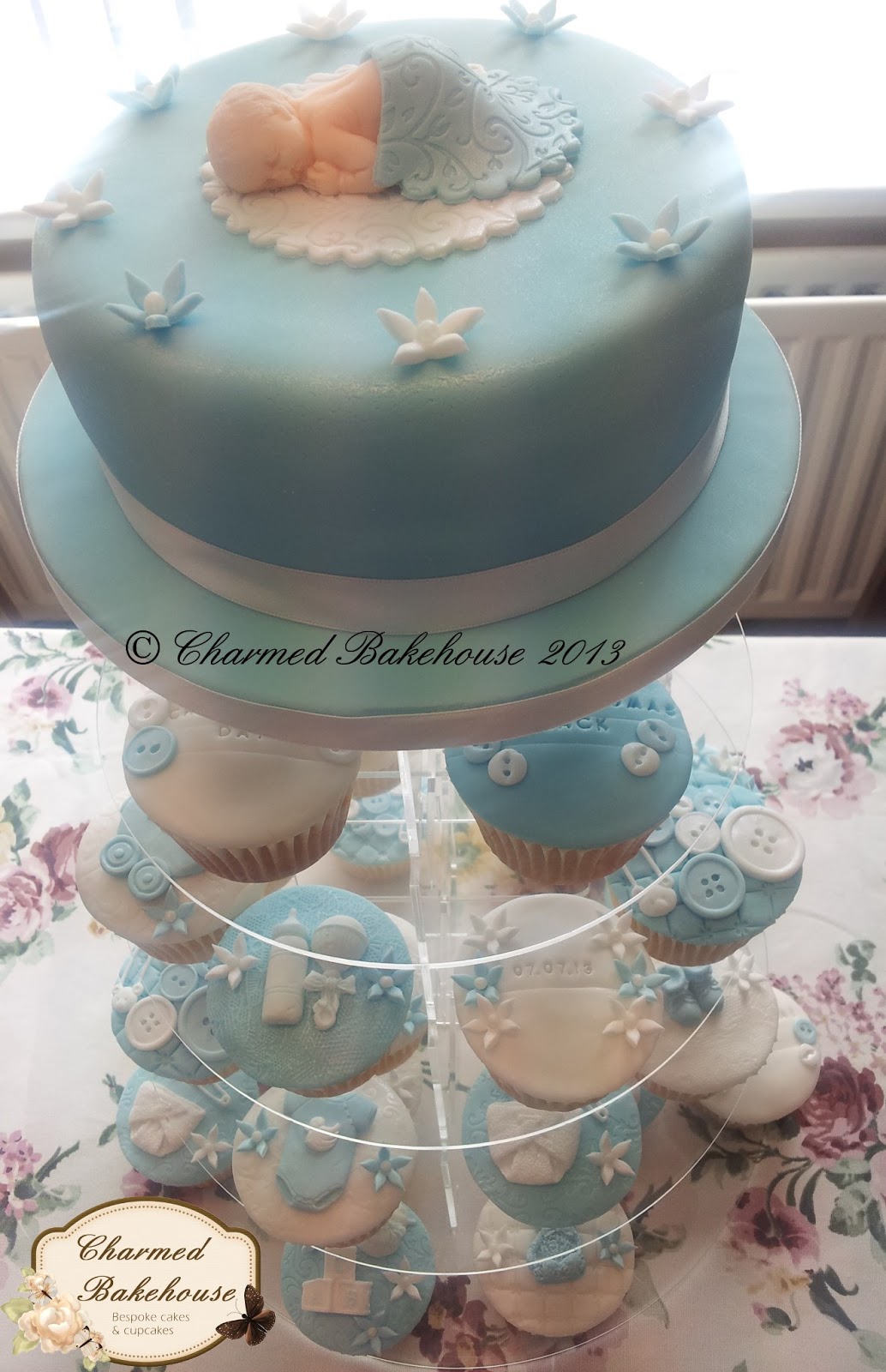 Christening cake and cupcakes displayed as a cupcake tower