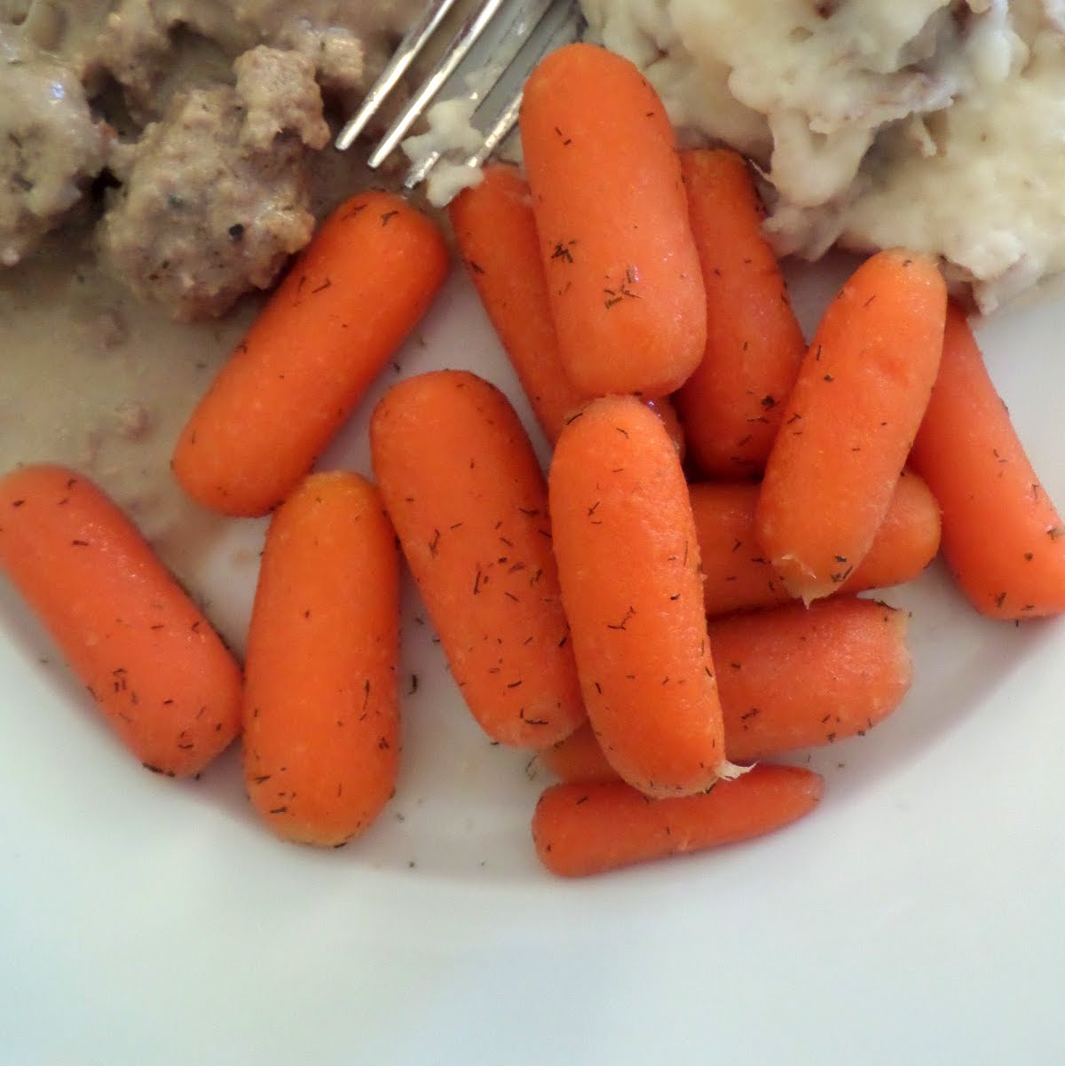 Sweet Dill Glazed Carrots:  Tender orange carrots cooked in a butter, brown sugar, and dill sauce.  A colorful and flavorful vegetable side dish.