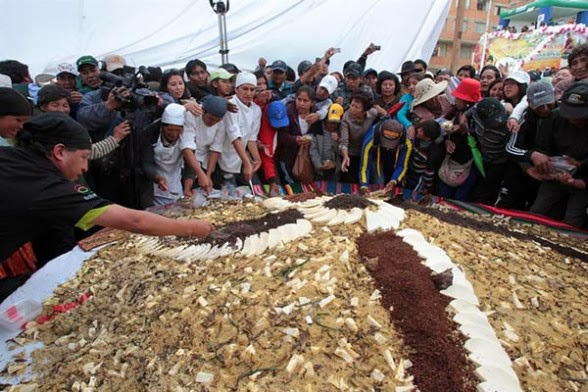 Ciudadanos bolivianos se sirven de un gigantesco plato de pisara