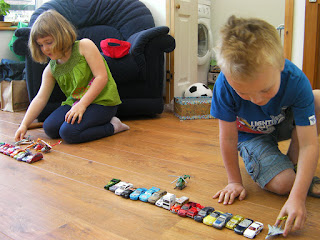 lining up toy cars on conservatory floor