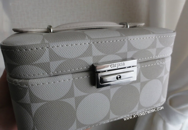 Carpisa jewelry case with taupe and white circle print