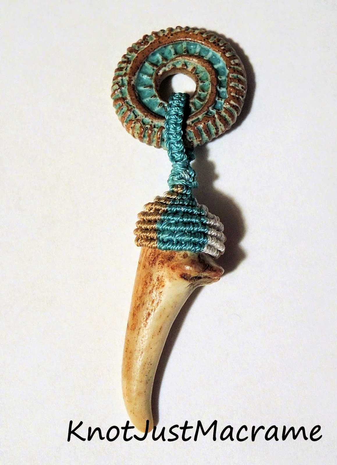 Deer antler tip with macrame knotting attached to a ceramic disc.