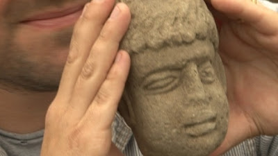 Carved head of Roman god found in ancient rubbish dump