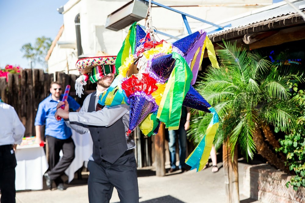groom hitting pinata, festive mexican themed wedding, aunt chiladas