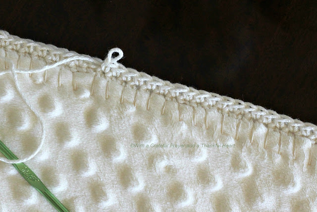 the blanket right-side out and began blanket-stitching around the edge ...