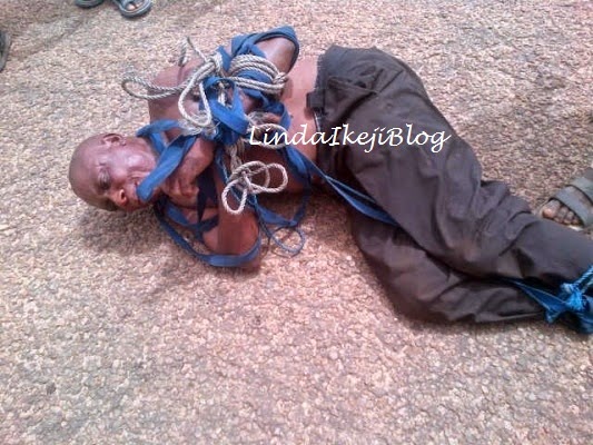 2 Photos: Policeman Beaten & Tied Up By Mob After Allegedly Shooting Driver