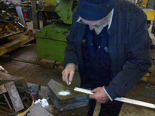 Ronnie marking out the new brake blocks for the Husky