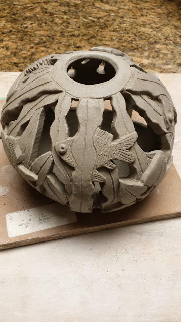 Ceramic handthrown carved pottery fish bowl sphere.