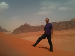 a man standing on a sand dune