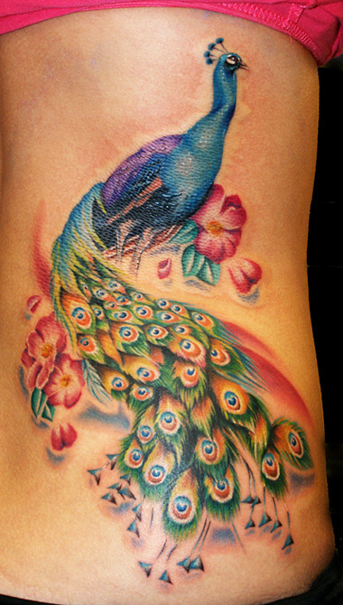 Above This colorful tattoo of a peacock is completed with flowers