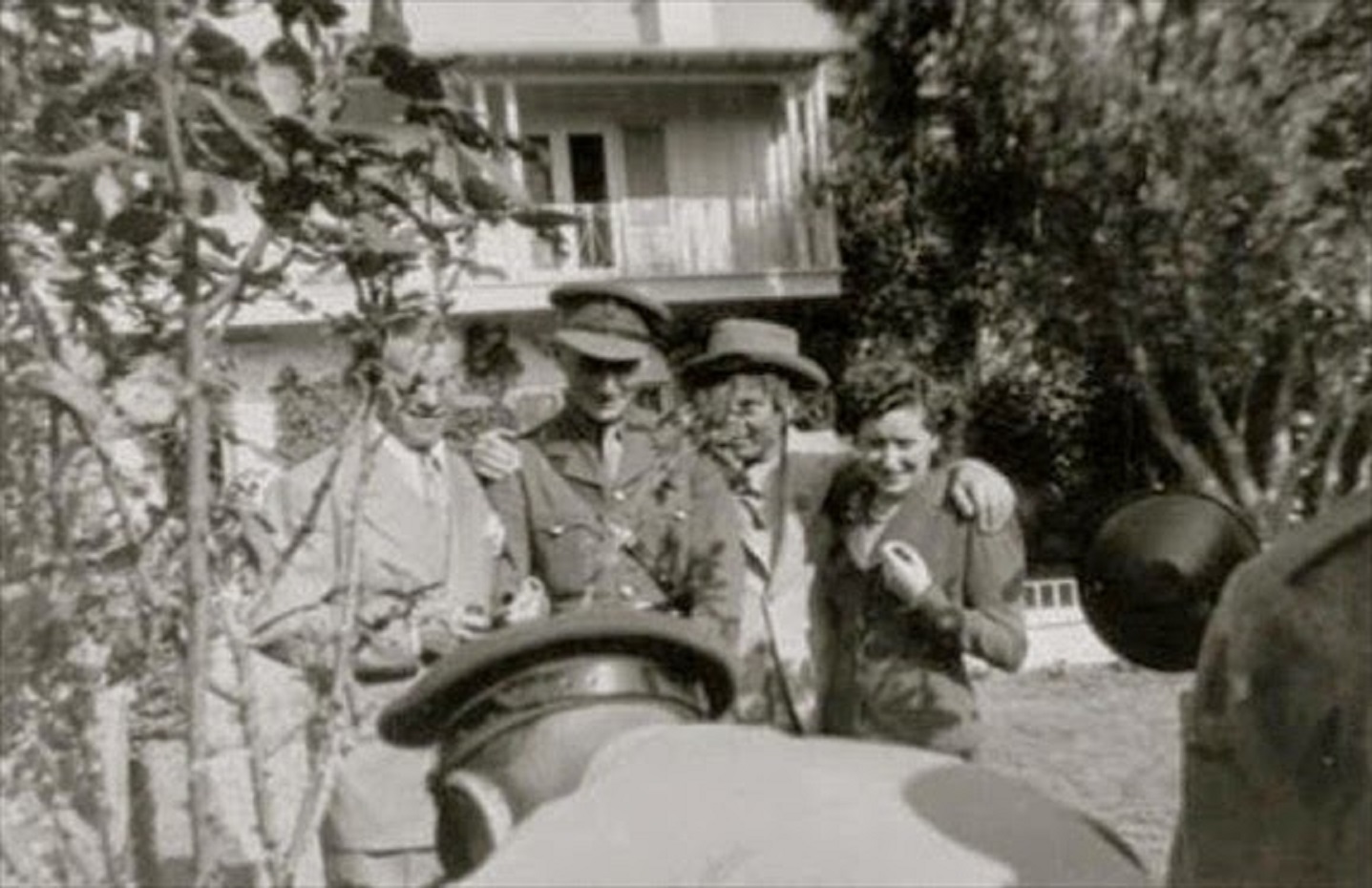 George Burns, Harpo Marx, and Gracie Allen with a fan at their home.