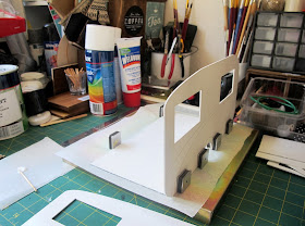 Dolls' house retro caravan kit side being glued to the base.