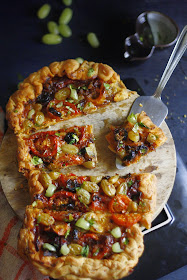 Summer perfect snack of easy tart with salsa as a base and green grapes, gouda cheese and tomato. 