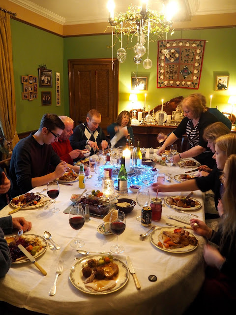 Family eating roast turkey and trimmings for dinner on Christmas day