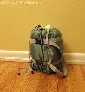 a green bag with straps on it