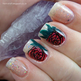 Romantic and sparkly nail art featuring roses and diamond glitter.