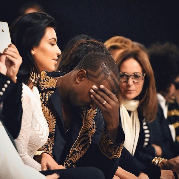 Kanye West wears Dries Van Noten Spring Summer 2014 gold embroidered coat to Balmain womenswear Spring Summer 2015 show at Paris Fashion Week.jpg