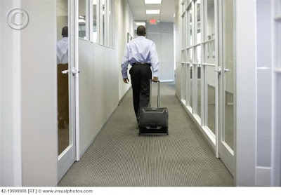businessman_rolling_briefcase_in_office_hallway_42-19999998.jpg