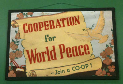 Early 20th century poster with dove and the words Cooperation for world peace -- join a co-op!
