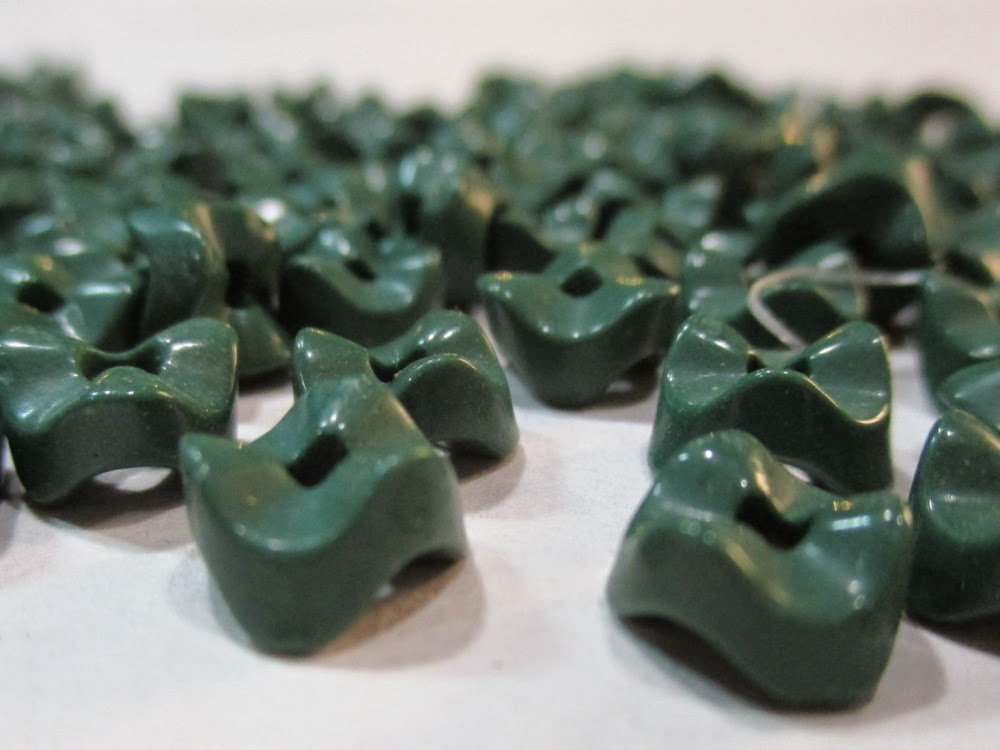 Green "vertebrae" glass beads https://www.etsy.com/listing/218478991/107-dark-green-glass-vertebrae-beads?ref=shop_home_active_10