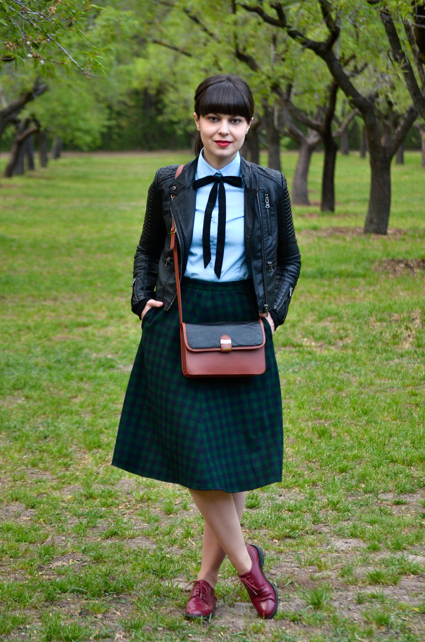 school girl outfit in madrid green tartan midi skirt thrifted brown bag satchel sky blue shirt black bow tie bangs burgundy oxford shoes poema spring green fresh park