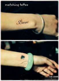 Matching tattoo with man's wrist inked with brave and girl's wrist inked with a heart.