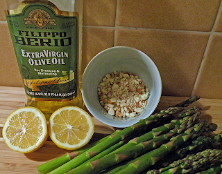 olive oil, cut lemon, chopped almonds, asparagus