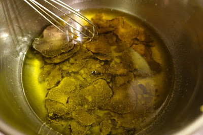 picture of thinly sliced truffles marinading in olive oil