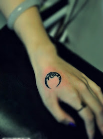 crescent moon tattoo on the hand