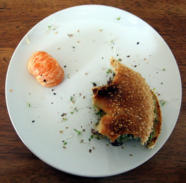 sesame bagel with hot roast beef, parmesan, and sprouts