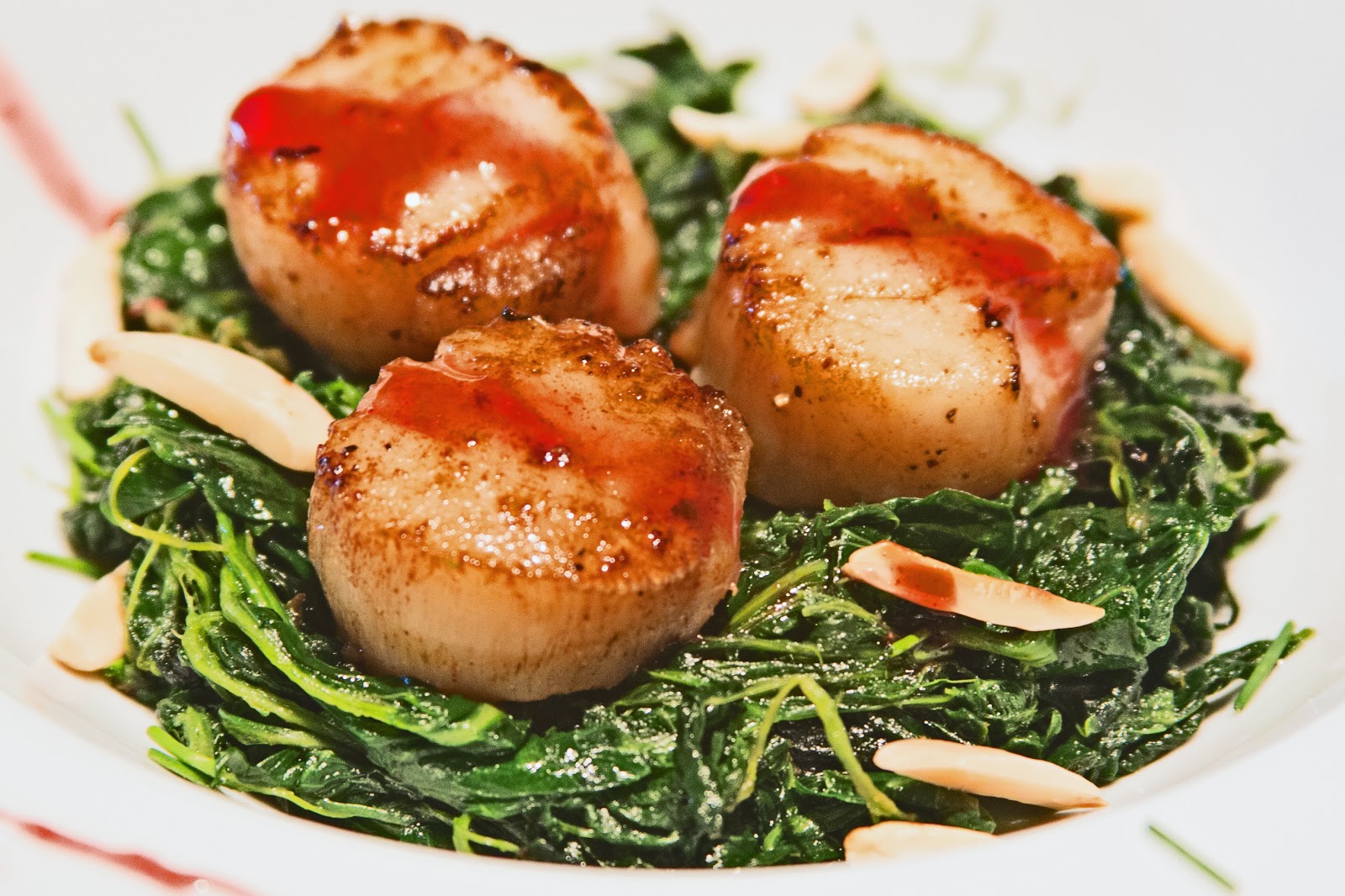 Pan Seared Scallops on Spinach with a Pomegranate Reduction Sauce the DIY food blog real