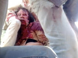 former-libyan-leader-muammar-gaddafi-covered-in-blood-is-held-on-a-truck-by-ntc-fighters-in-sirte-in-this-still-image-taken-from-video-footage-oct-20-2011.jpg