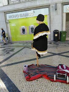 Street artist floating on air  on Rua Augusta in Lisbon.