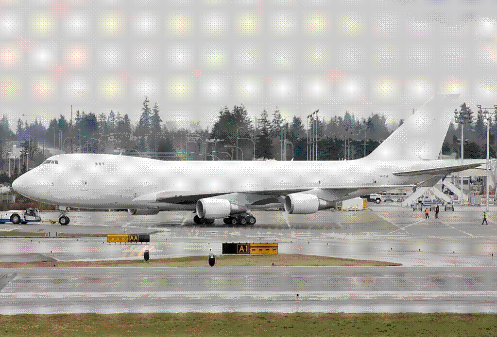 I saw an all white 747 with no windows or markings landing at DFW