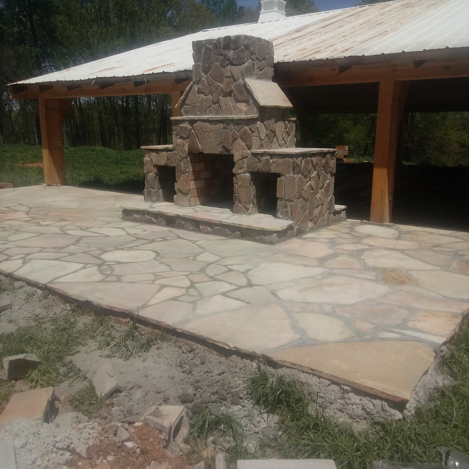 Stone outdoor fireplace and patio