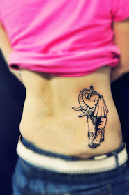 a smiling elephant tattoo on the hip