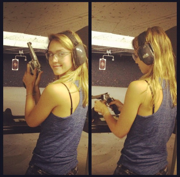 Jessica Alba smiles at a camera before firing her gun 