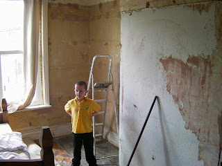 stripping wallpaper and sweeping up