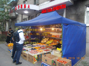 Grocery and a fruit stall outside the Apartment building housing "Art Hostel" in Almaty.