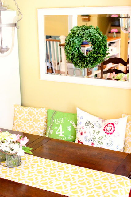 Preserved Boxwood wreath on mirror in dining area via www.goldenboysandme.com