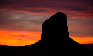 The overcast sky breaks just enough during this sunset in Monument Valley, Arizona.