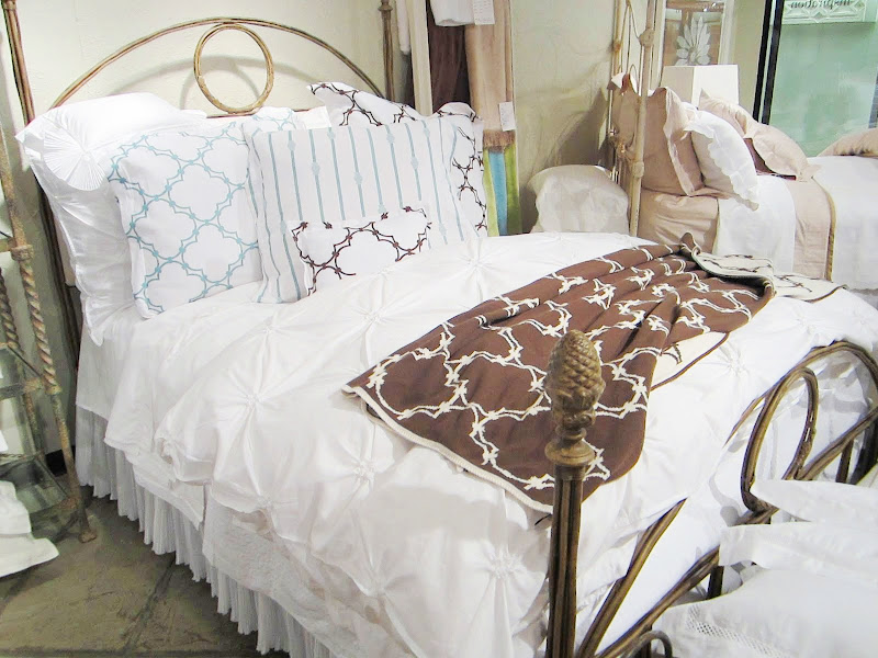 Nbaynadamas throw, shams and boudoir pillows on an elegant white Downtown Company duvet cover in the Christian Mosso & Associates Showroom in Atlant