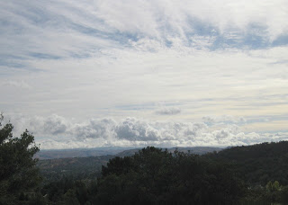 Overcast sky, with huge puffy clouds above the Diablo Range