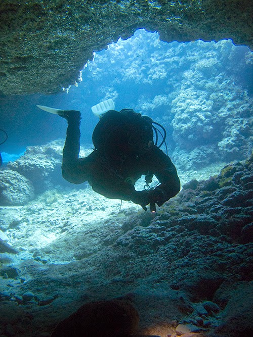Scuba Diver inside underwater cavern in Protaras, Cyprus hovers with good buoyancy and trim