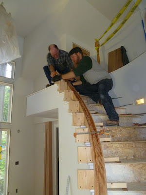 Shawn Christman and Christian Leach of Seattle Stair measure a hand crafted cherry handrail in Juneau, Alaska