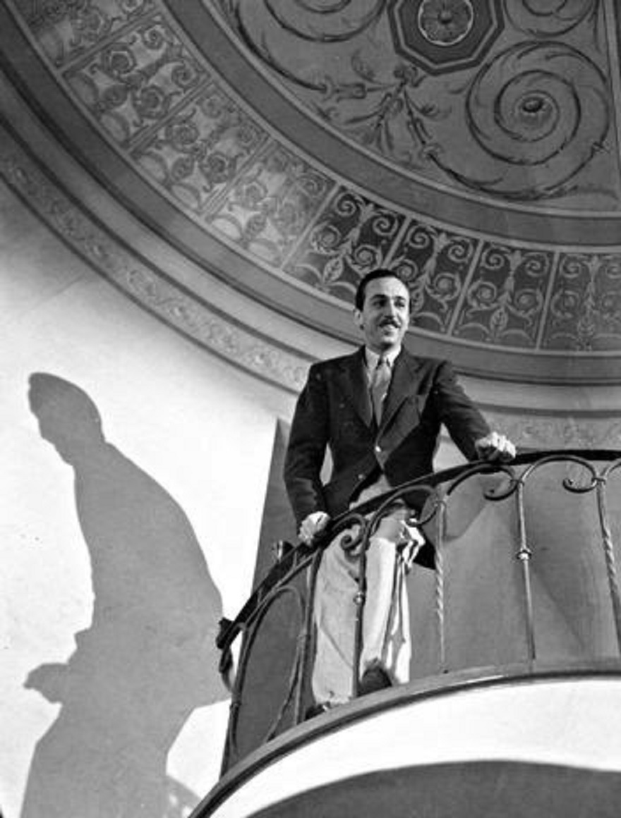 Walt standing on the balcony of his staircase.