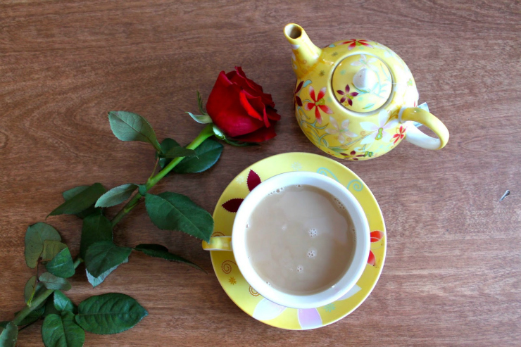 Caramel colored sweater, drinking tea with red lipstick
