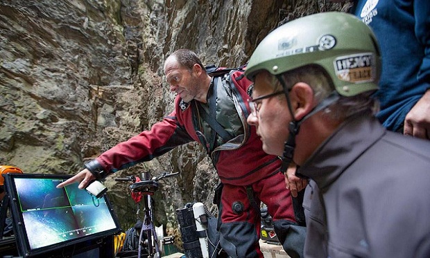 In this photo taken Sept. 27, 2016 in the flooded Hranicka Propast, or Hranice Abyss, in the Czech Republic Polish explorer Krzysztof Starnawski, left, and Bartlomiej Grynda, right, are reading images from a remotely-operated underwater robot, or ROV, that went to the record depth of 404 meters ,1,325 feet, revealing the limestone abyss to be the world's deepest flooded cave, during the 'Hranicka Propast - step beyond 400m' expedition led by Starnawski and partly funded by the National Geographic. (AP Photo/ Marcin Jamkowski) In this photo taken Sept. 27, 2016 in the flooded Hranicka Propast, or Hranice Abyss, in the Czech Republic Polish explorer Krzysztof Starnawski, left, and Bartlomiej Grynda, right, are reading images from a remotely-operated underwater robot, or ROV, that went to the record depth of 404 meters ,1,325 feet, revealing the limestone abyss to be the world's deepest flooded cave, during the 'Hranicka Propast - step beyond 400m' expedition led by Starnawski and partly funded by the National Geographic. (AP Photo/ Marcin Jamkowski)