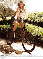 Kylie Minogue in shorts riding a bicycle