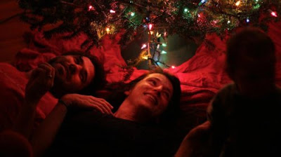 laying under Christmas tree laying under Christmas tree